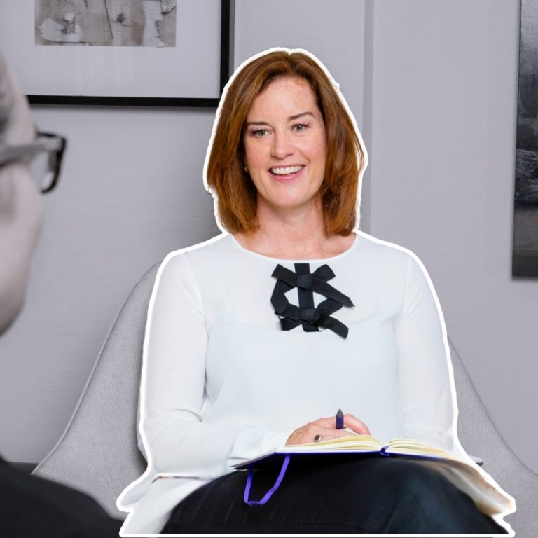 Smiling woman in 1 to 1 coaching session.